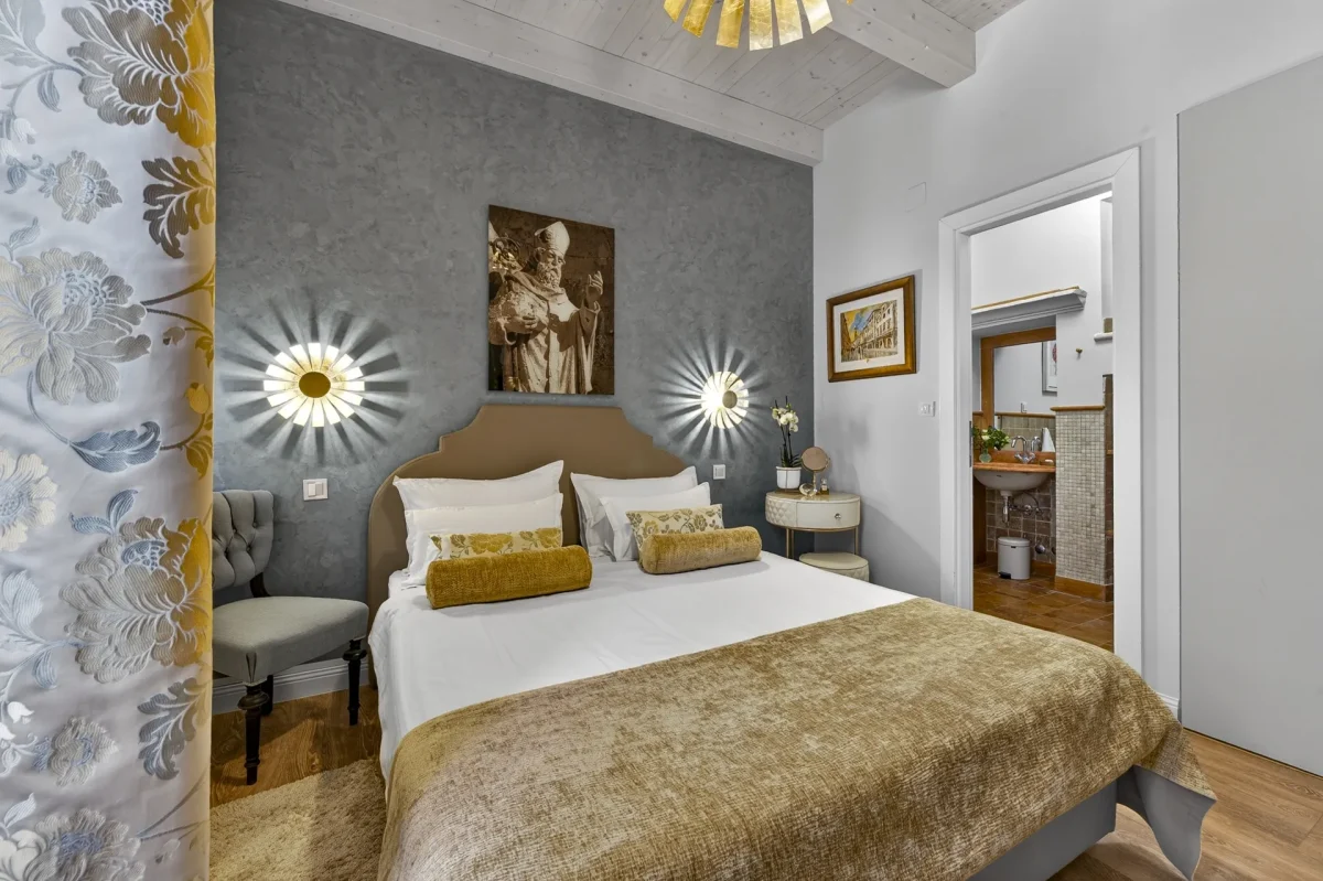 Deluxe Double Room at Dominus Little Palace in Dubrovnik Old Town with double bed, gold sunburst wall lights and en-suite bathroom