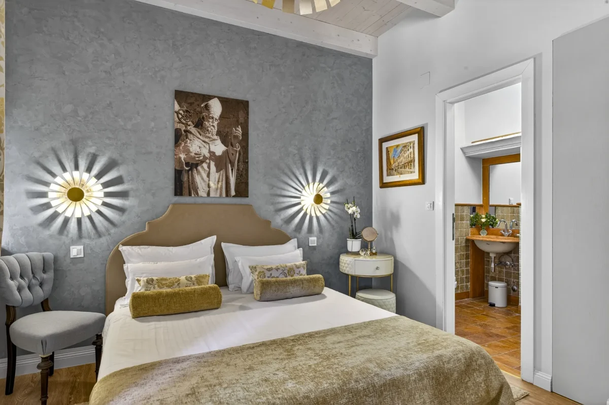 Deluxe Double Room in Dubrovnik Old Town with blue-grey feature wall, St. Blaise artwork and gold-accented bedding