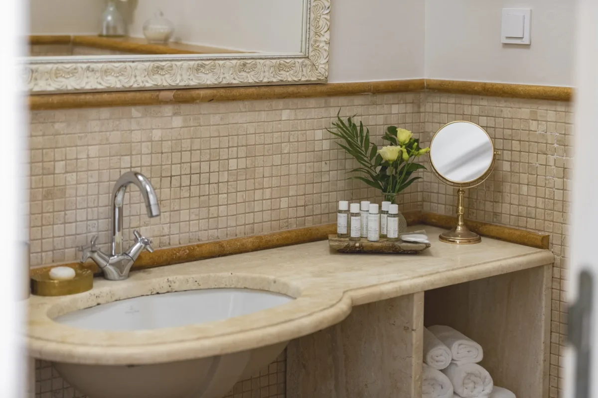 Corner of the Premium Double bathroom vanity with rolled towels, flowers and magnifying mirror